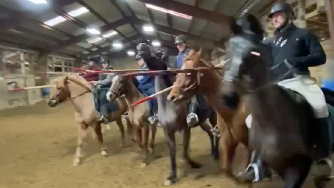 Horseback lancers doing a cavalry charge