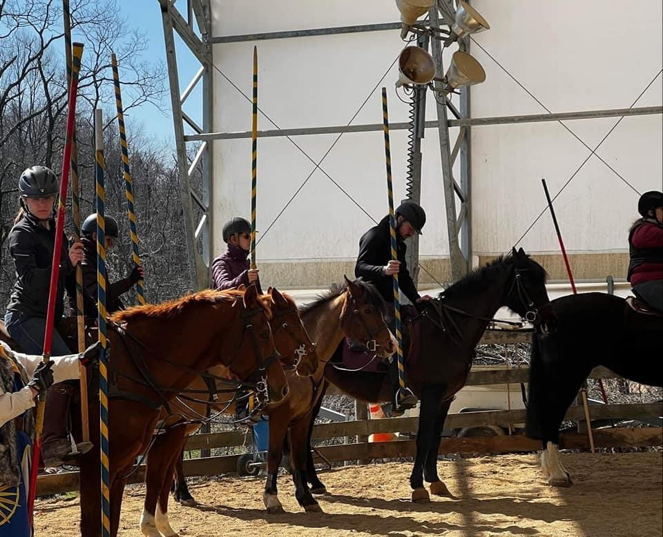 Horseback riders with painted lances waiting to play skill at arms games