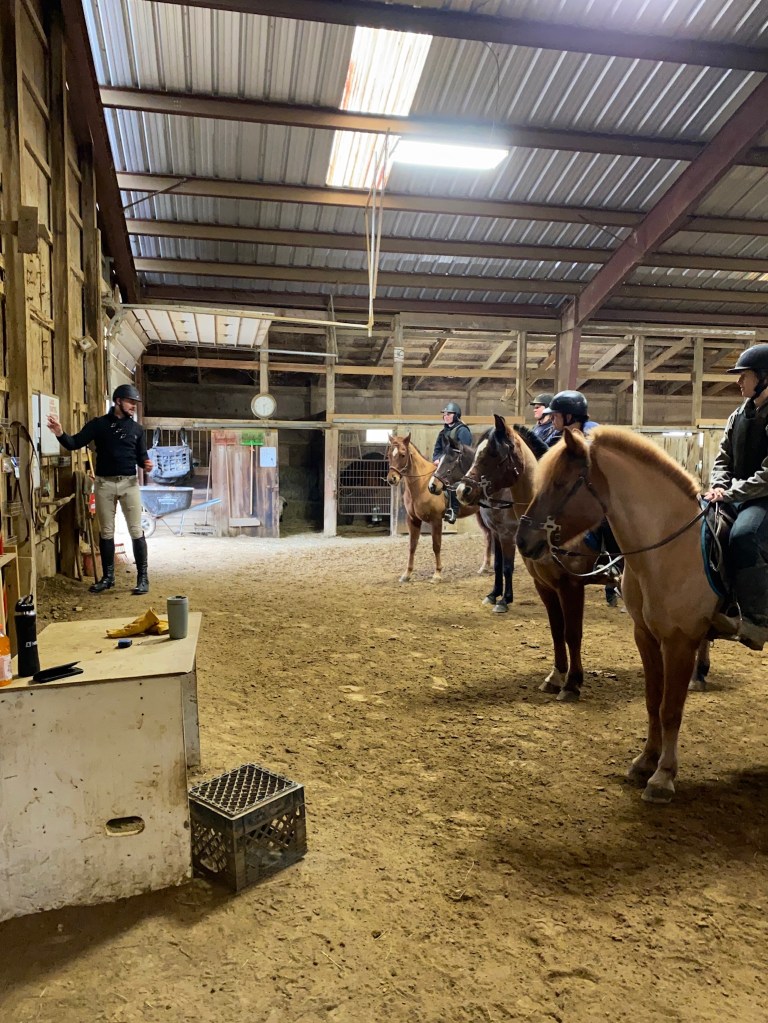 Horseback riding instructor teaching a group of horseback riders how to do Martial arts in formations