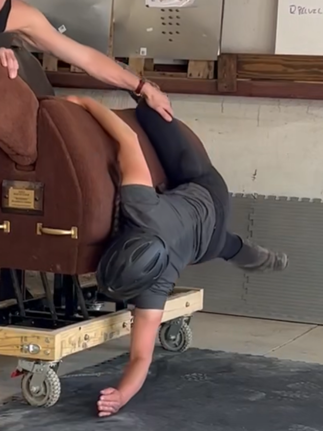 Mongol Derby rider practicing falling off a wooden horse.