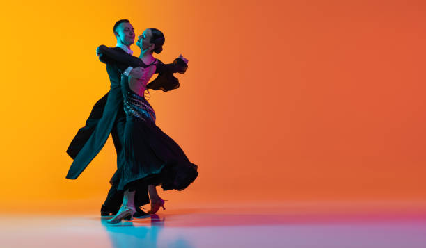 Man and woman dancing a ballroom dance in dance wear